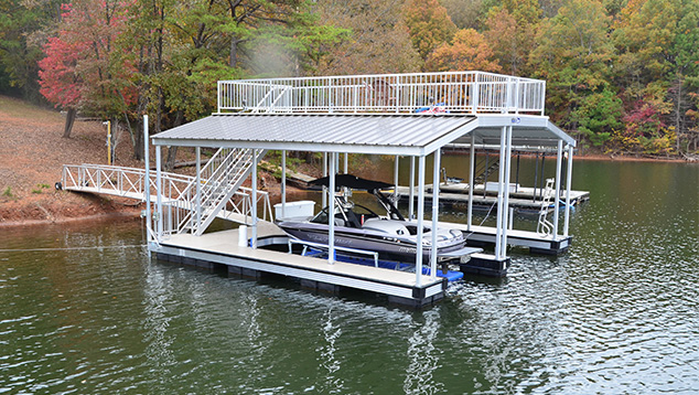 Custom dock with sundeck roof design by Kroeger Marine, providing full coverage and durability for lakeside protection